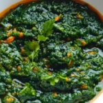 Freshly harvested pumpkin leaves on a rustic wooden table, showcasing their vibrant green color and healthy texture.