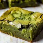 Close-up of freshly baked matcha brownies with a fudgy texture and vibrant green color.