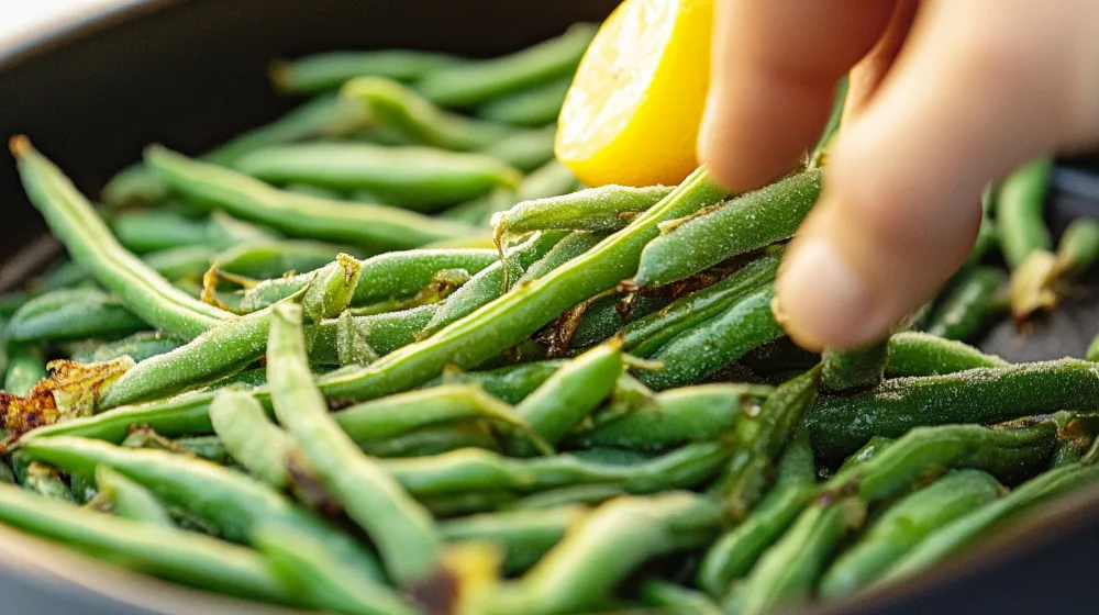 Cooked frozen green beans in a skillet, garnished with garlic and Parmesan cheese, ready to serve.