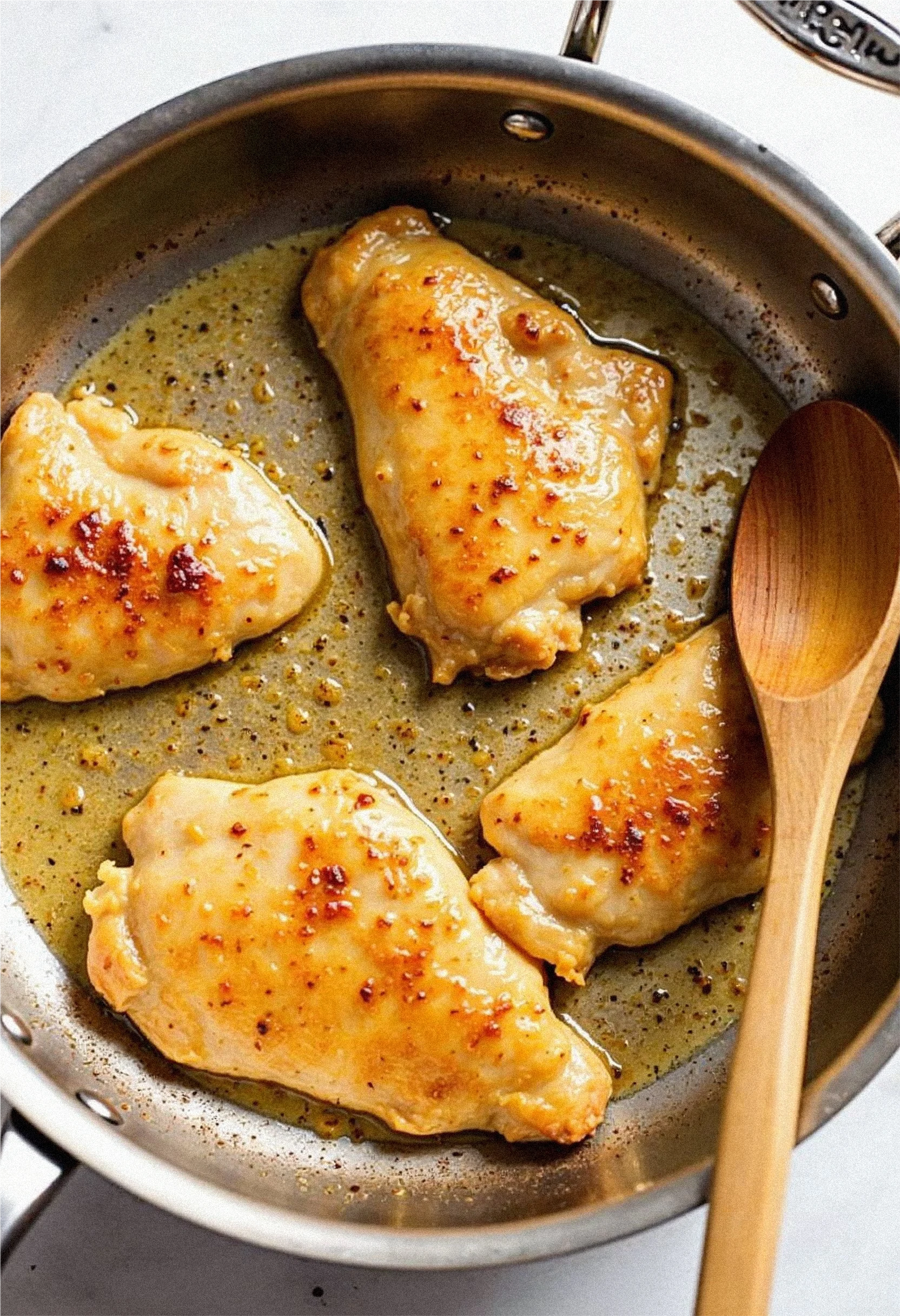 Chicken breasts searing in a skillet for Marry Me Chicken.